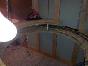 unattached parts of a helix railroad model with tools and model train