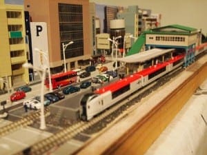 train station with parking lot in Japan-themed railroad model