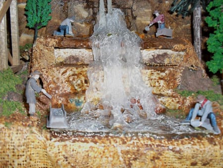people at the waterfalls of the model railroad