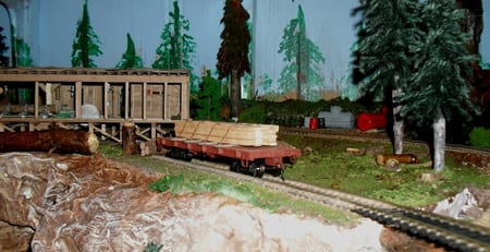 cart with wooden cross the model train tracks' bridge