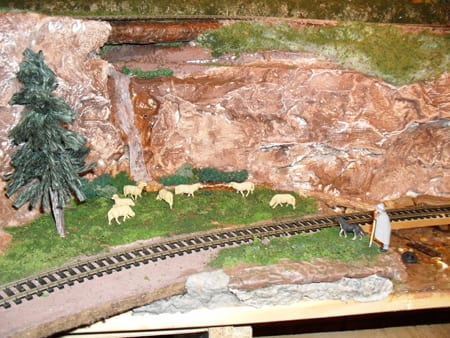 sheep next to train tracks on model railroad