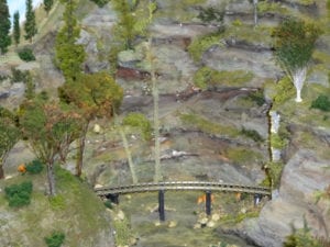 part of the model train track by the mountain with animals and trees