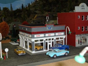 car dealership and barbershop in model railroad