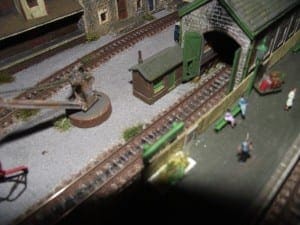 Entrance of a garage for the model train beside the platform.