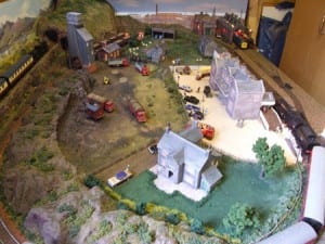 Overhead view of the model train layout, showing houses, trains, and a tunnel.