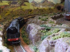 Black model train along a curve.