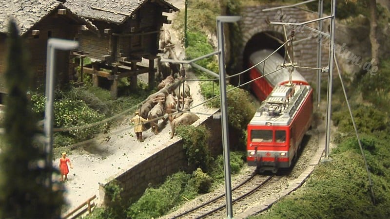a model train crossing a tunnel