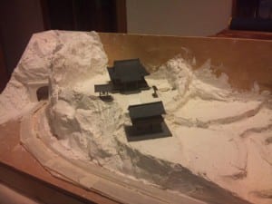 unpainted japanese houses and tunnel of model railroad