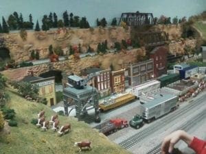 buildings, trucks, bridges, and cows of model railroad