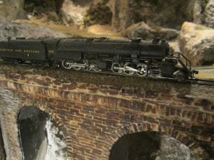 model train crossing brick bridge