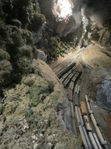 model trains at the foot of the mountain