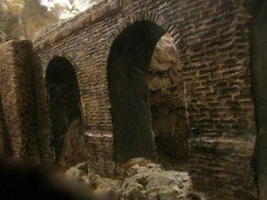 Details of the arches of an old brick bridge on the model railroad.