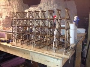 wires running along the model railroad bridge's foundation