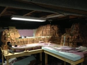 view of the model railroad with bridge, waterfall, mountains, and tunnels
