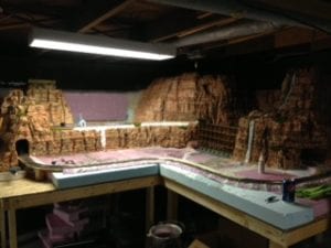panoramic view of the model railroad with mountains, church, and waterfalls