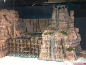 bridge, waterfall, and tunnel entrance on model railroad