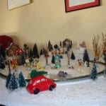 Cartoon characters, cars, and trees on the model railroad during Christmas. 