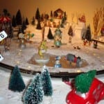 Characters on a frozen pond on the model railroad layout.