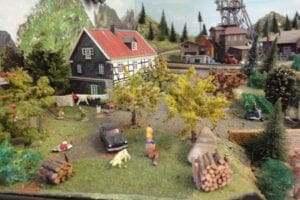 children playing in the backyard of the model railroad.