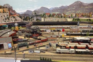 Backdrop of mountains with model trains. 
