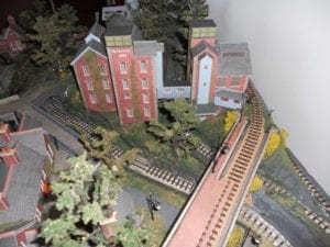 red and blue buildings beside train tracks and bridge