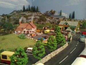 pink and brown buildings in the muddleton village model railroad