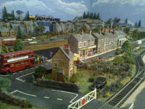 Red double decker busses on the model railroad