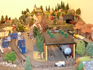 Vehicles and buildings in the model railroad layout.