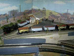 airedale carts on tracks of model railroad