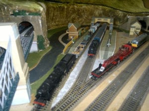 trains and houses near train station of model railroad