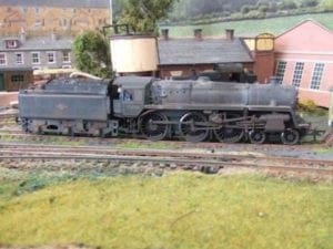 Weathered locomotive at the end of a track.
