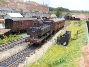 Locomotives resting by the grass. 