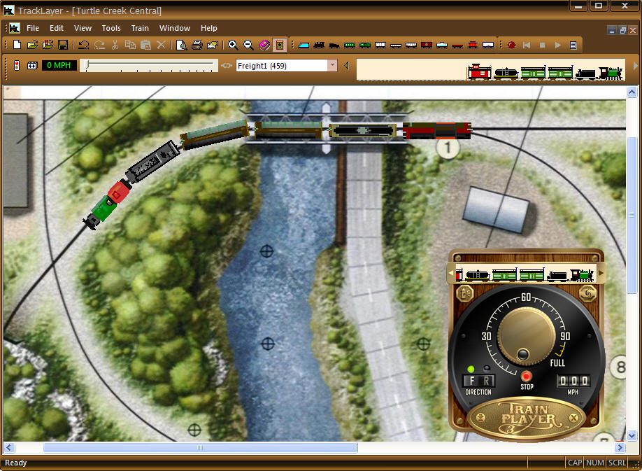 TrainPlayer TrackLayer window with a freight train running past a river on the Turtle Creek Central layout