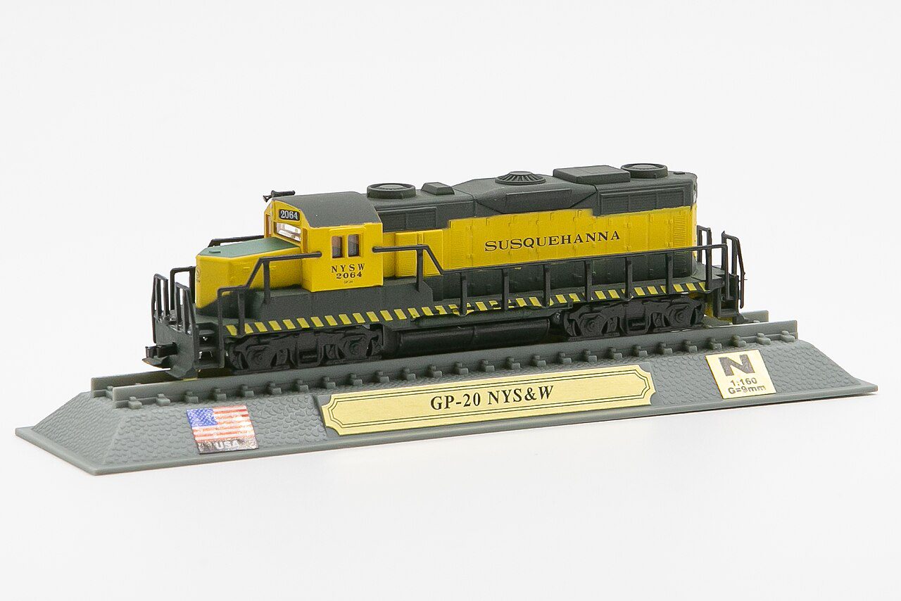 An N scale EMD GP20 diesel locomotive model in yellow and dark gray on a display base
