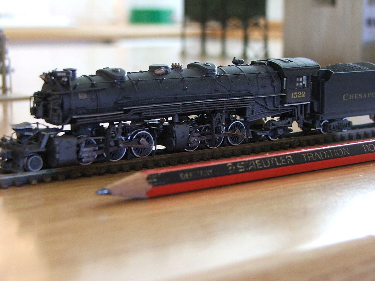 Bachmann N scale 2-6-6-2 steam locomotive on track beside a pencil for size